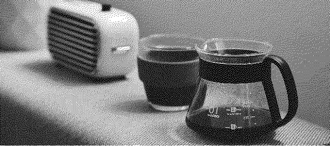 Photo of a coffee pot with a cup and an old radio..